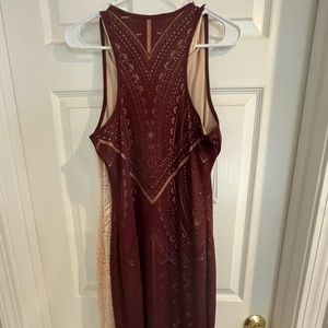 Two identical dresses - one peach and the other maroon.  Side slits.
